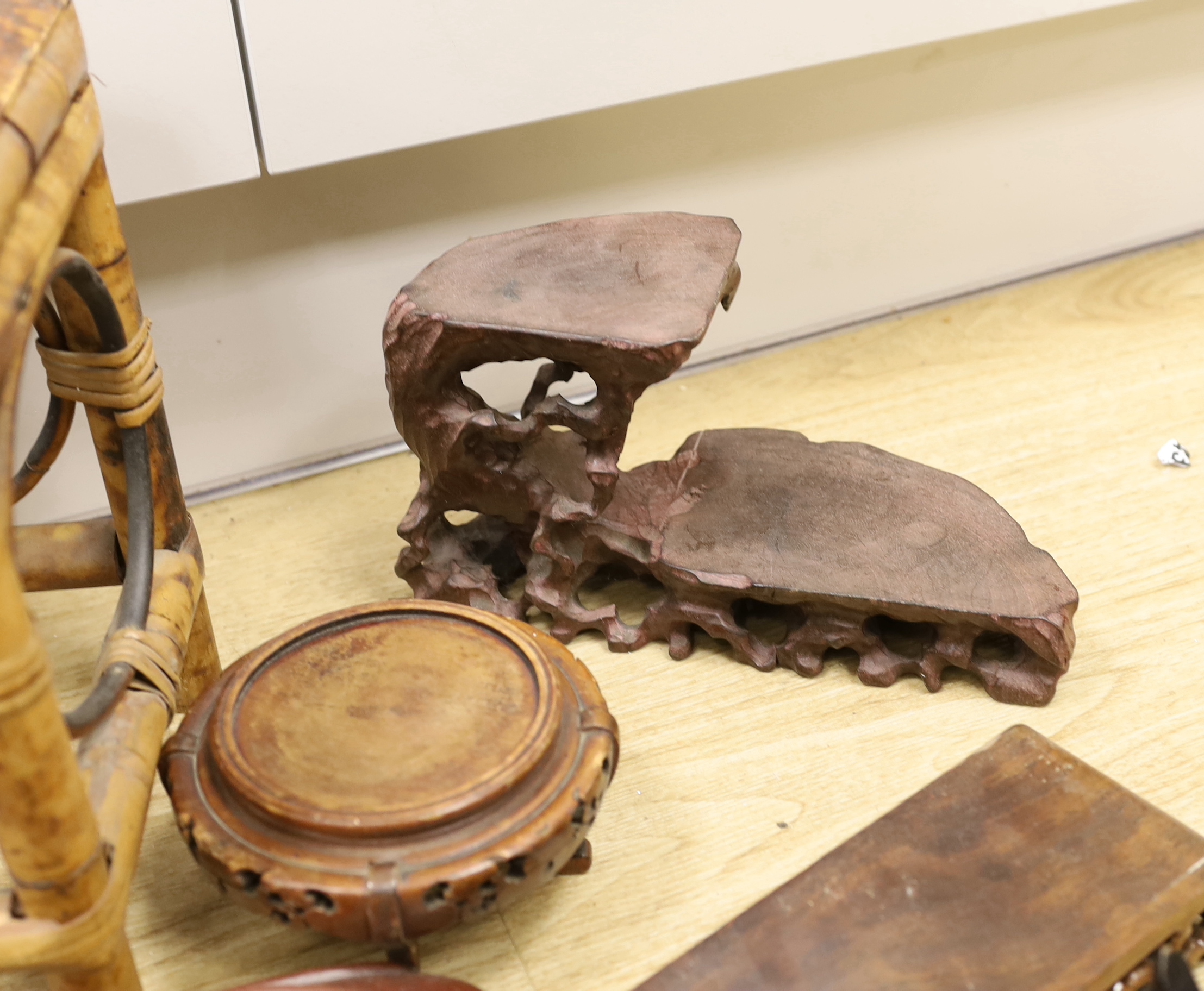A collection of Chinese carved wooden stands and a small bamboo stand